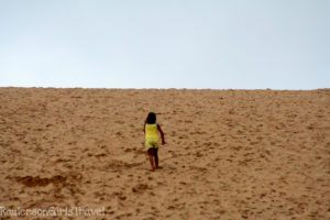 A Child Climbing Up the Dune Climb