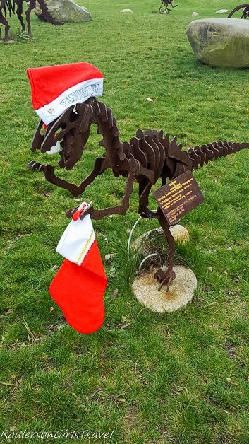 Metal Velociraptor statue decorated for the holidays at Dinosaur Farm in Coloma, Michigan