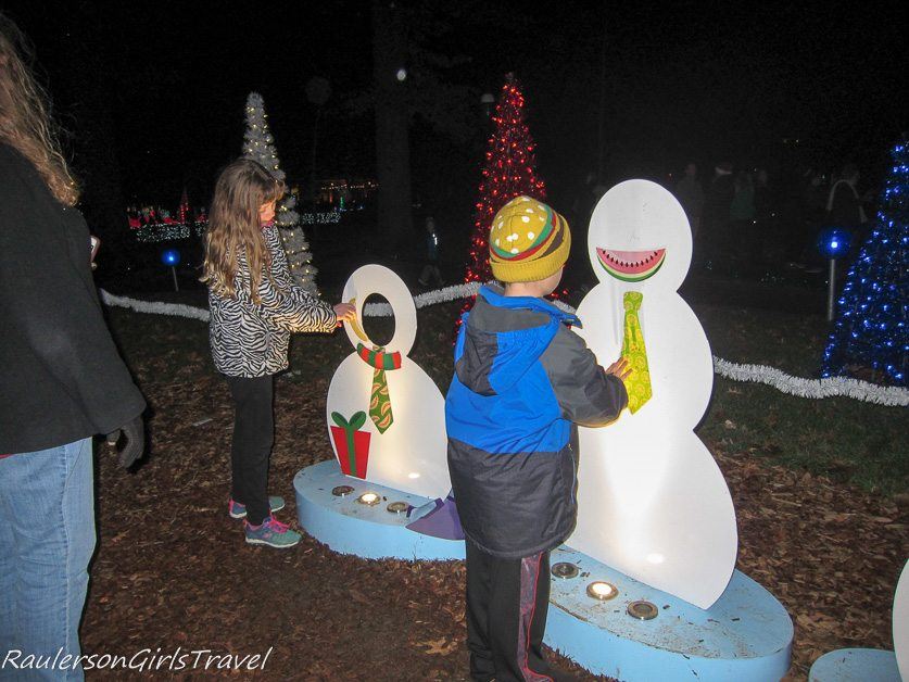 Children decorating snowman at Garden Glow at Missouri Botanical Gardens