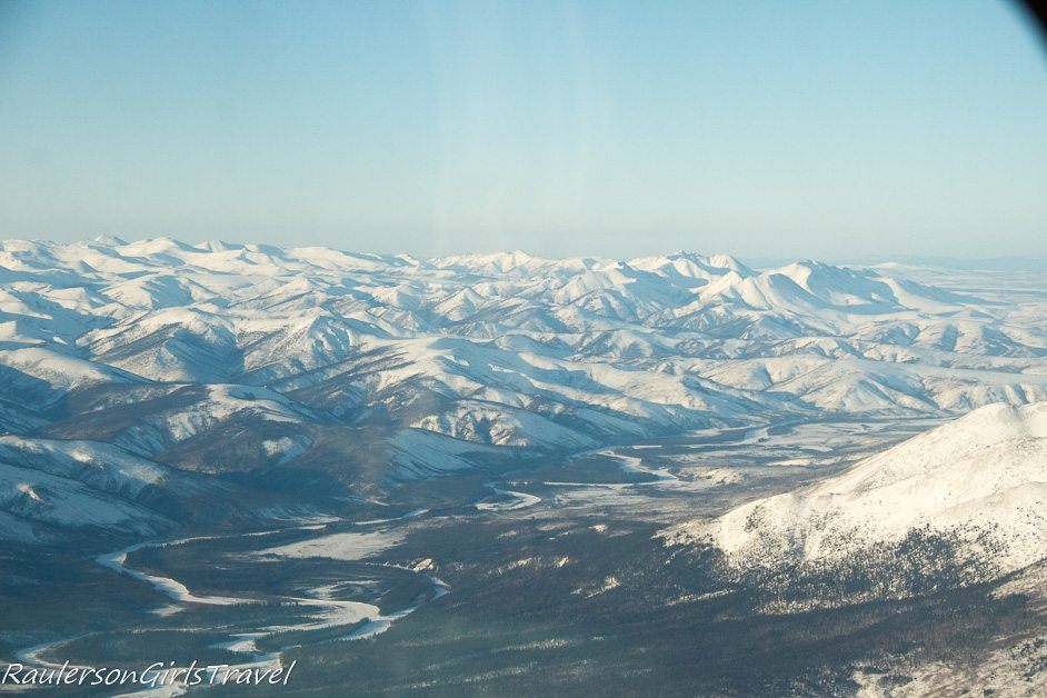 Alaskan mountain range and river view from the plane