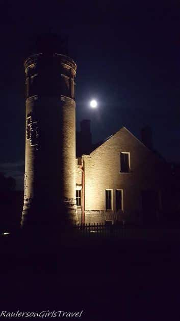 Old Mackinac Point Lighthouse at night with moon