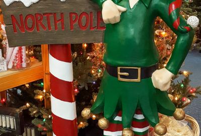 North Pole Elf by Christmas Tree