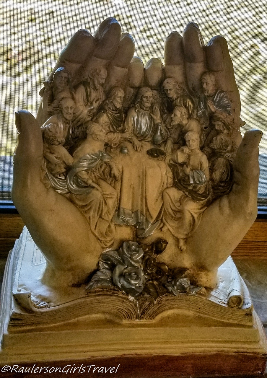 Bronze Jesus and Disciples in hands on a book in the Chapel of Our Lady of the Sierras