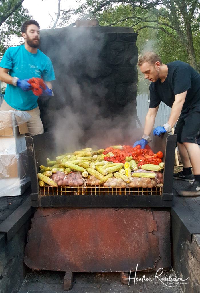 Moving the food around to be steamed at Fosters Clambake