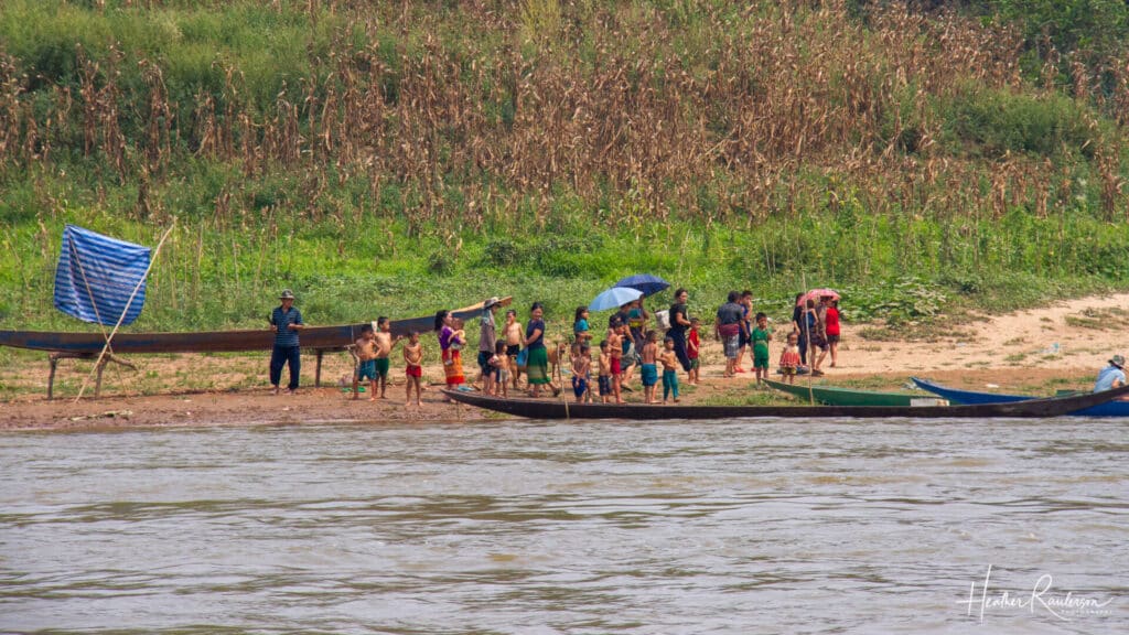 Laotians villagers waiting for boats on the Mekong River