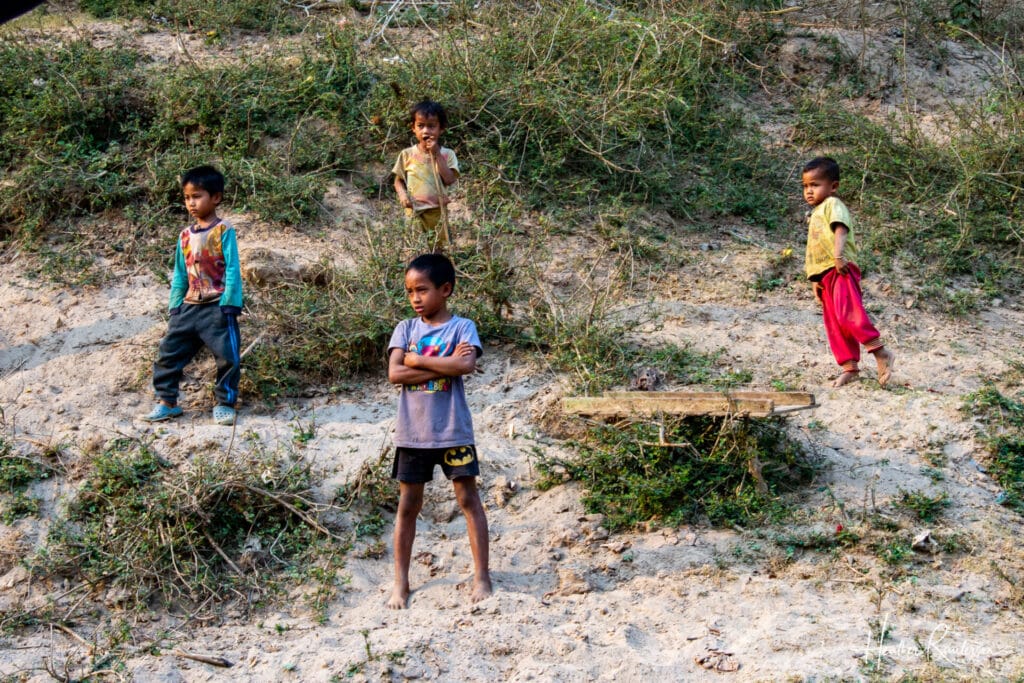 Kids standing on the bank of the Mekong River