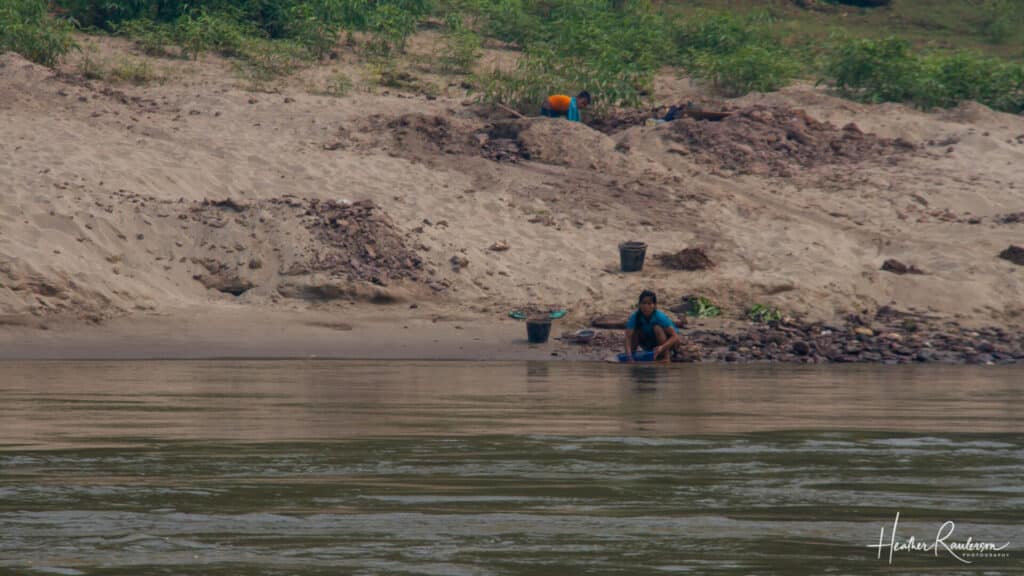 Laos woman doing laundry in the Mekong River