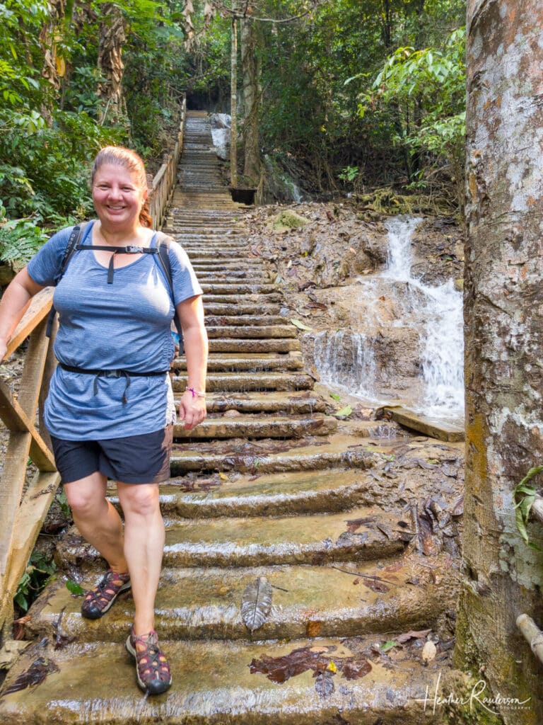 Heather walking down the watery steps at Kuang Si Falls