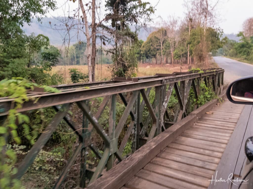 Traveling on a wooden bridge in Laos