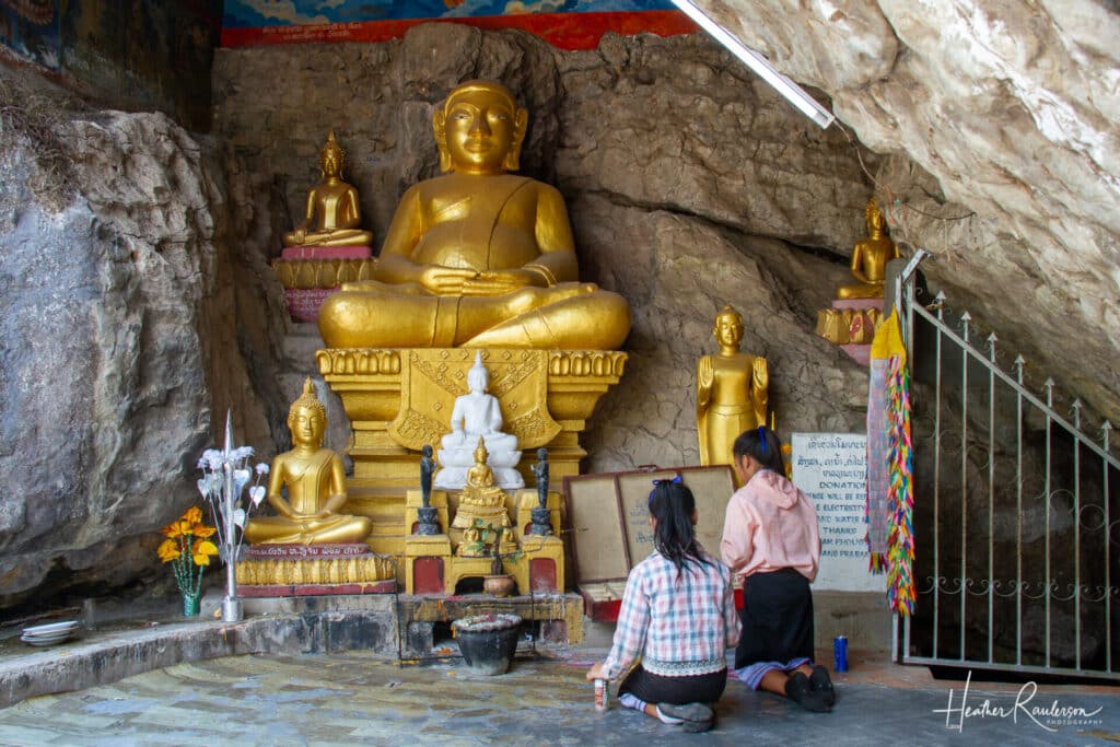 Praying in front of the Buddha statue on Mount Phousi