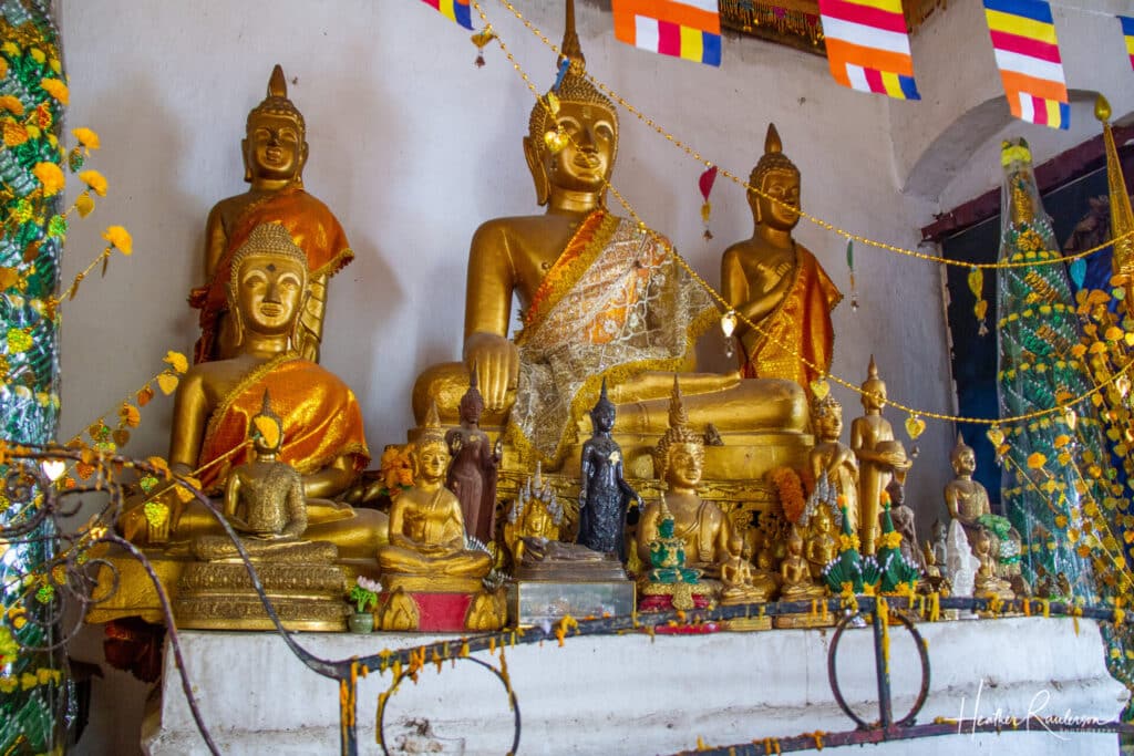 Buddha statues inside the Wat Chom Si temple at Mount Phousi
