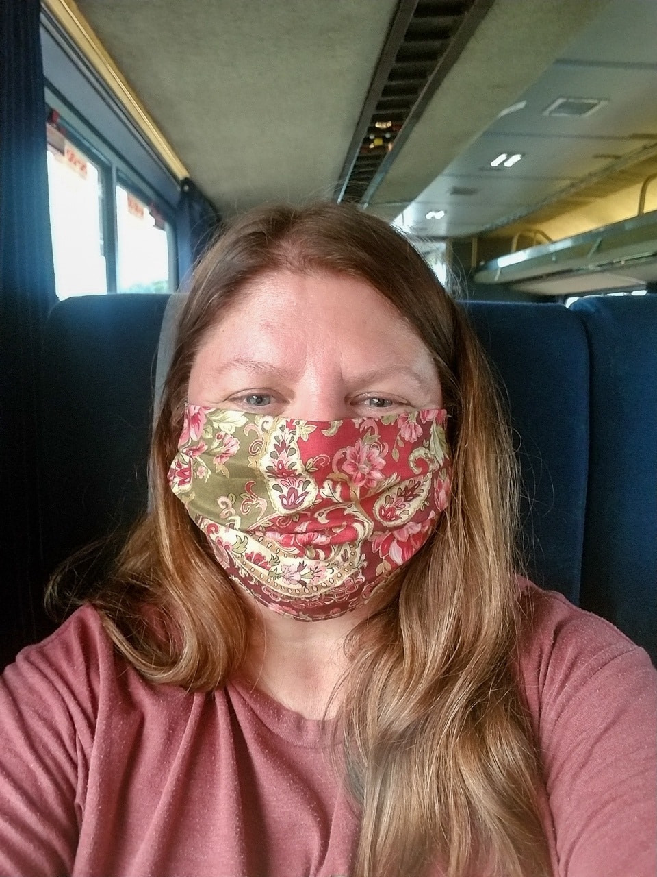 Heather wearing a mask on the Amtrak train