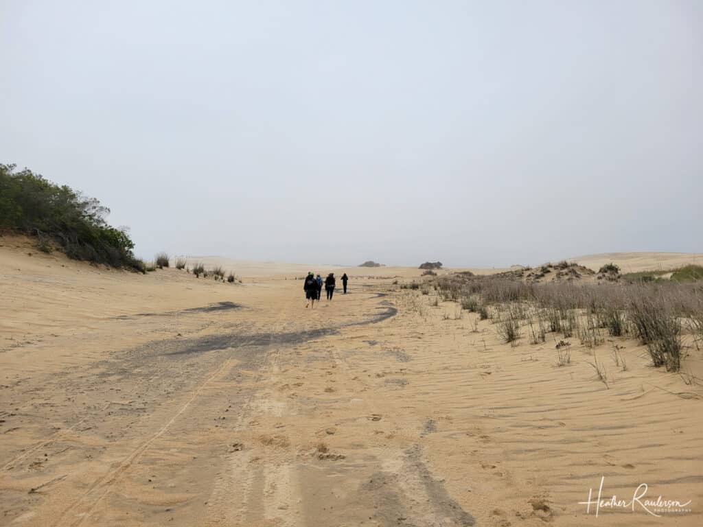 Walking to the sand dune for hang gliding